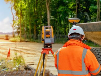 surveyor-site-engineer-with-total-positioning-station-construction-site-new-road-construction